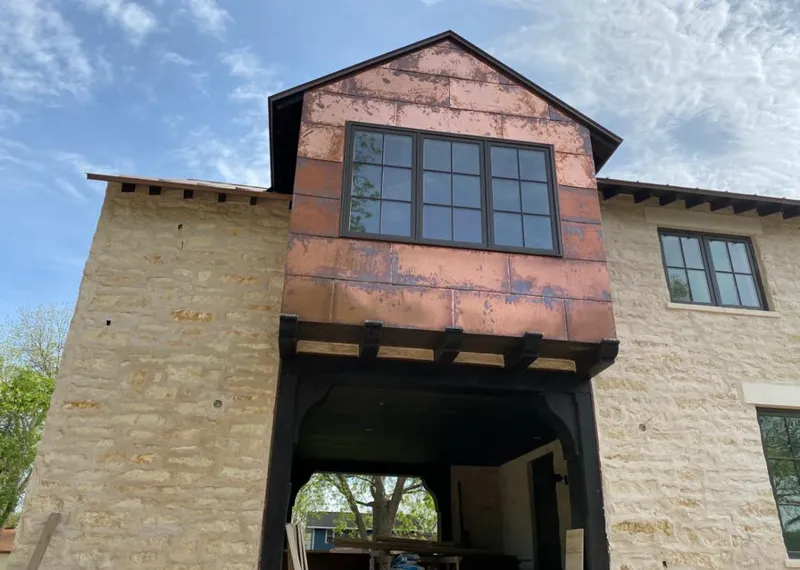 Copper metal panel facade on a stone building for Metal Roof Coating in Le Mars
