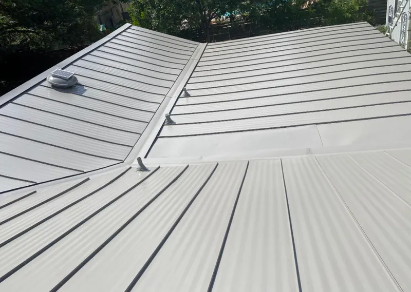 Solar attic fan installed on a metal roof for Roof Ventilation in Le Mars